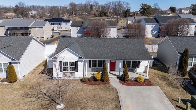 ranch-style home with a shingled roof and a residential view