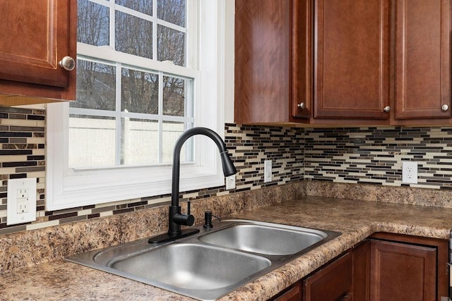 kitchen featuring a sink and decorative backsplash