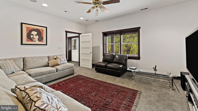 living room with ceiling fan and carpet