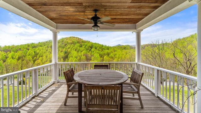 wooden deck featuring ceiling fan