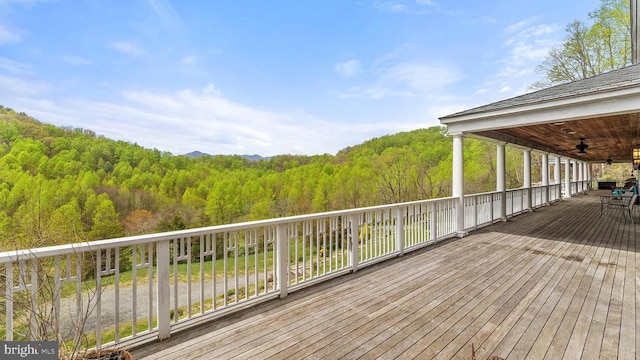 wooden deck featuring ceiling fan