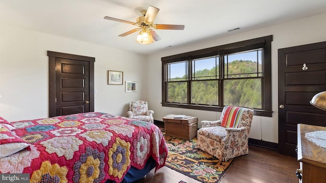 bedroom with ceiling fan and dark hardwood / wood-style floors