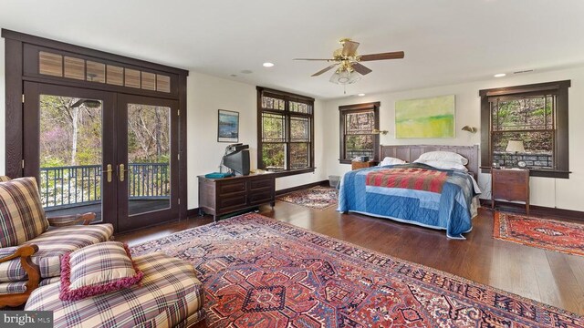 bedroom with multiple windows, wood-type flooring, access to outside, and french doors