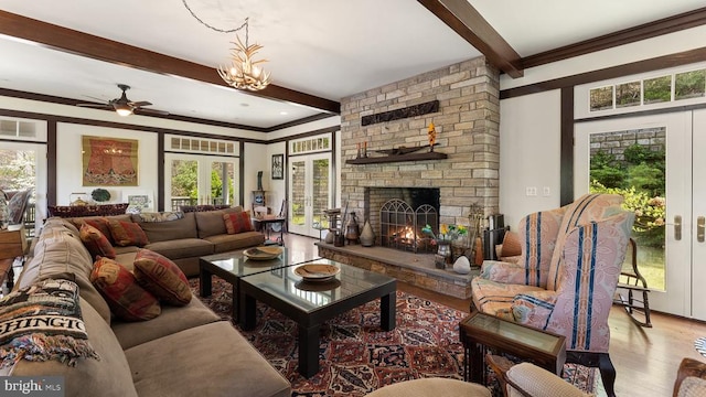 living room with beam ceiling, a fireplace, french doors, and wood-type flooring