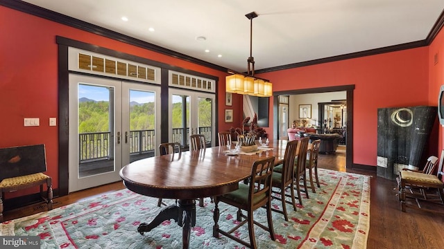 dining space featuring ornamental molding, dark hardwood / wood-style flooring, and french doors