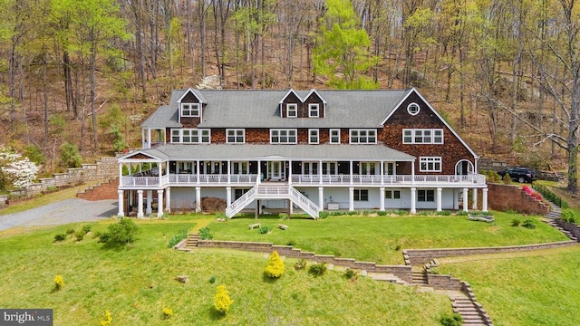 back of property featuring a yard and a deck