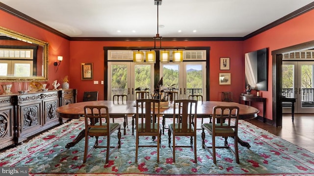 dining space featuring crown molding, dark hardwood / wood-style floors, french doors, and a chandelier