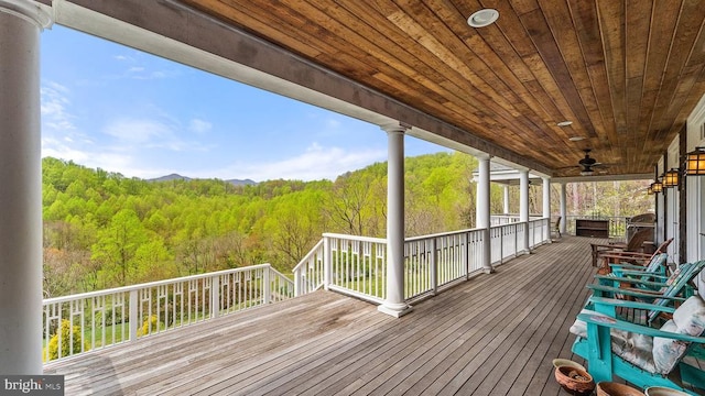 wooden deck featuring ceiling fan