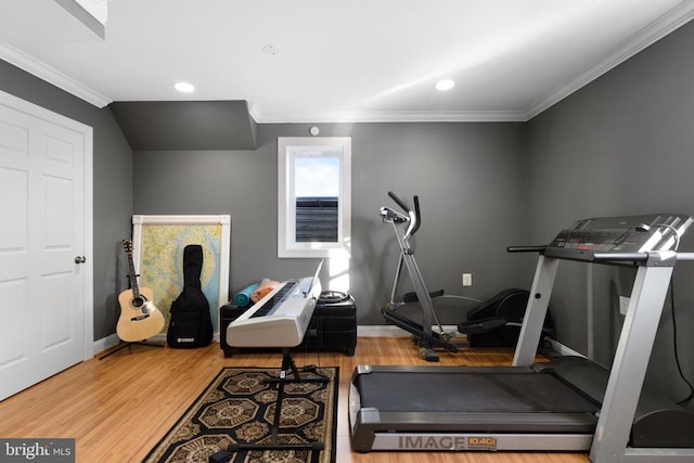 workout room with crown molding and hardwood / wood-style floors