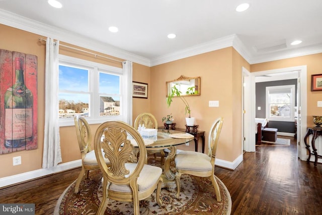 dining space with ornamental molding and dark hardwood / wood-style floors