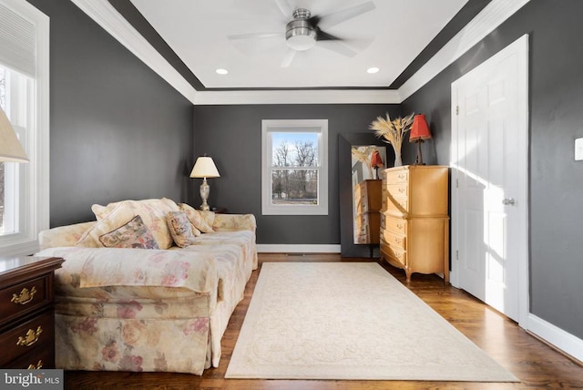 bedroom with wood-type flooring, ceiling fan, and crown molding