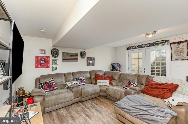 living area featuring french doors and light wood-style flooring