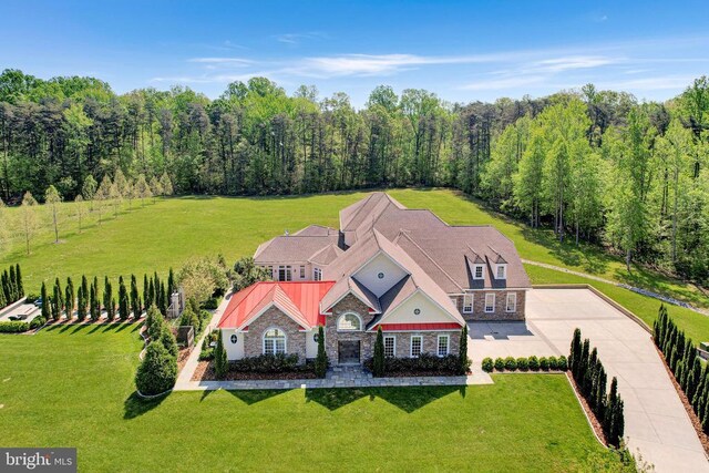 drone / aerial view with a wooded view