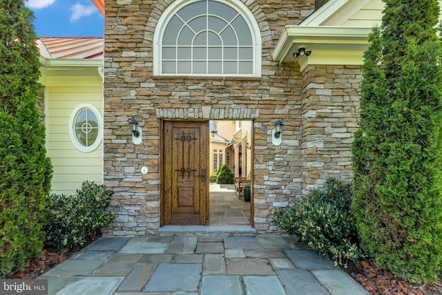 doorway to property featuring stone siding