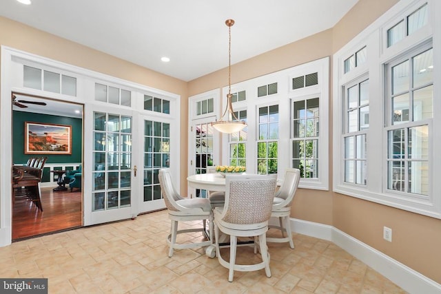 sunroom with baseboards, french doors, recessed lighting, and stone finish flooring