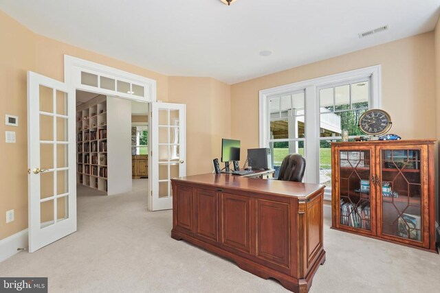 home office featuring light colored carpet and french doors