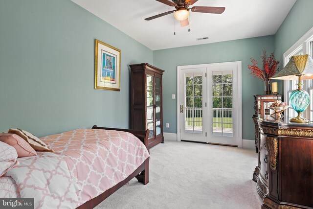 carpeted bedroom with multiple windows, access to exterior, and ceiling fan