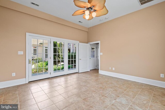 tiled spare room featuring ceiling fan