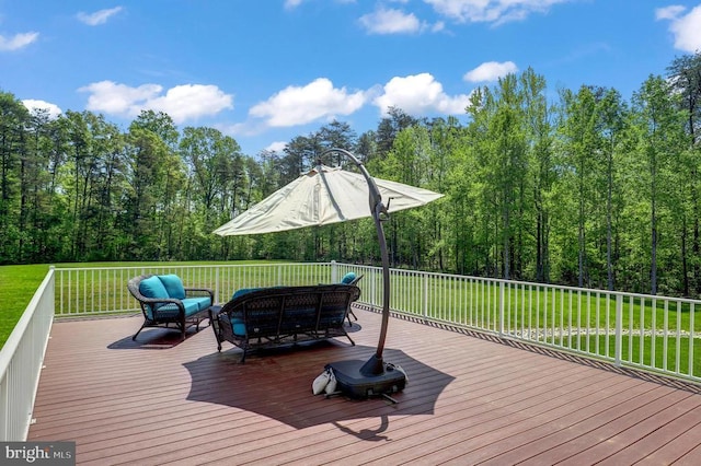 wooden terrace with outdoor lounge area, a yard, and a forest view