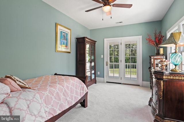 bedroom featuring multiple windows, light carpet, visible vents, and access to exterior