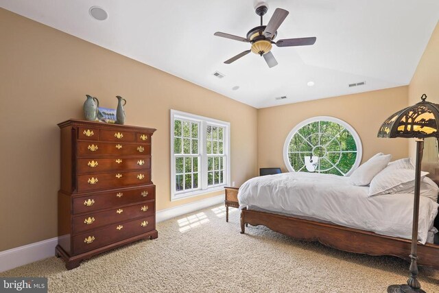 bedroom featuring multiple windows, light colored carpet, lofted ceiling, and ceiling fan