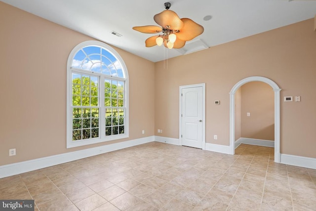 unfurnished room with light tile patterned floors, baseboards, a ceiling fan, and visible vents