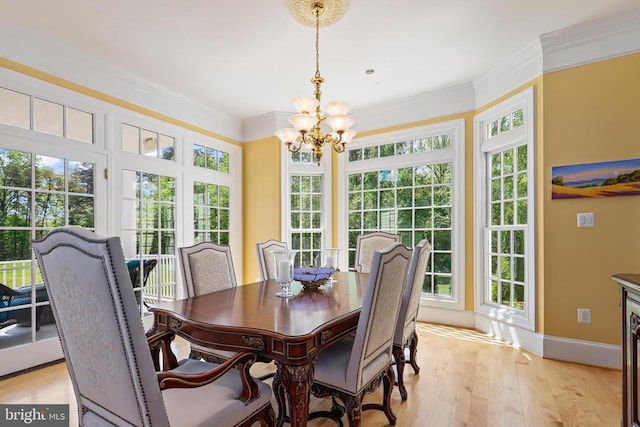 dining space with a chandelier, plenty of natural light, and light wood-style floors