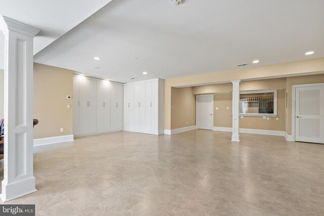 unfurnished living room featuring decorative columns