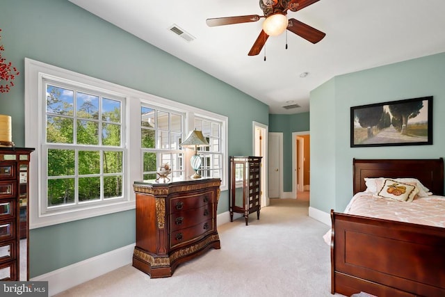 bedroom featuring baseboards, multiple windows, light colored carpet, and visible vents