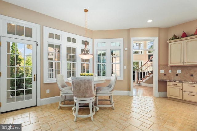 dining area featuring stairway, baseboards, recessed lighting, and stone tile flooring