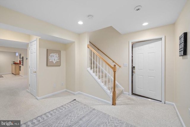 entryway with carpet, recessed lighting, baseboards, and stairs