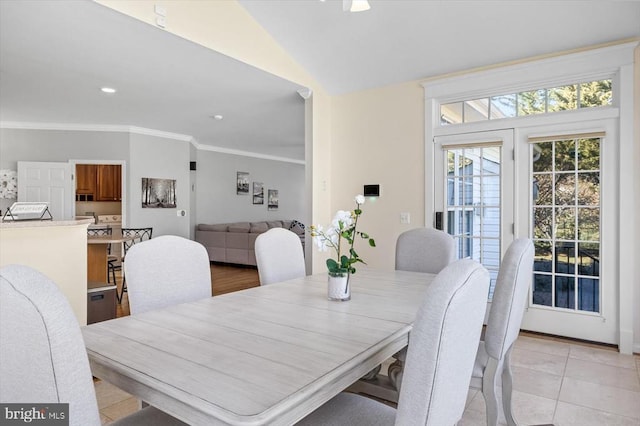 dining space with lofted ceiling, ornamental molding, light tile patterned flooring, and recessed lighting