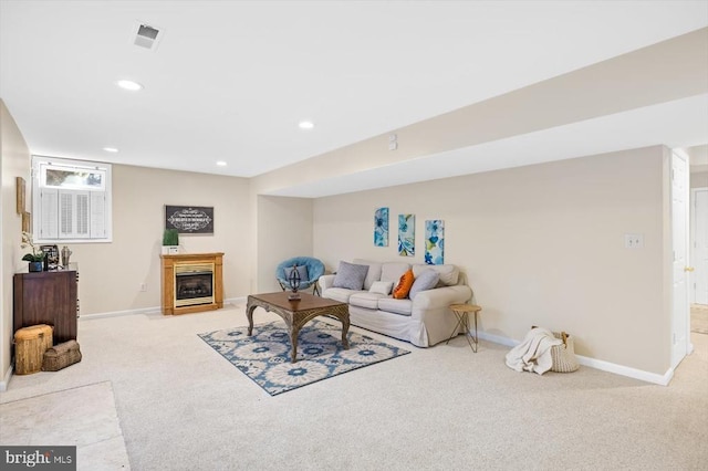 living room with recessed lighting, light colored carpet, a fireplace, and baseboards