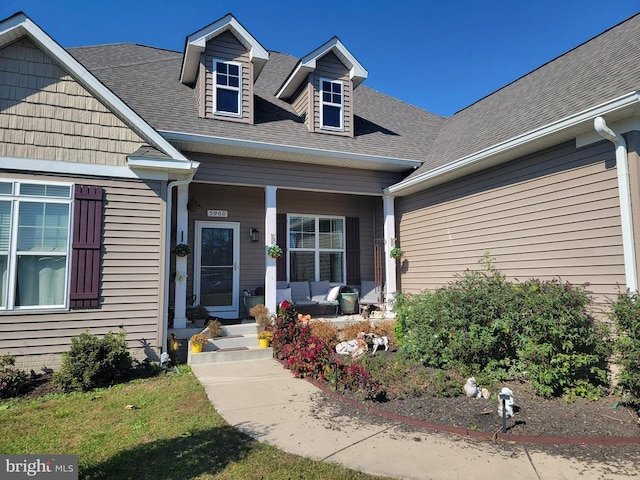 view of front of house with a porch and roof with shingles