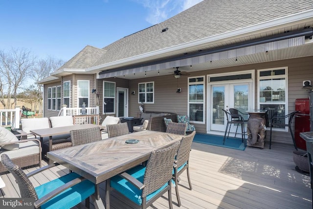 wooden deck with french doors, outdoor lounge area, a ceiling fan, and outdoor dining space