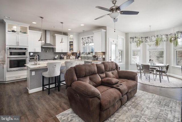 living room featuring dark wood-style floors, baseboards, and recessed lighting