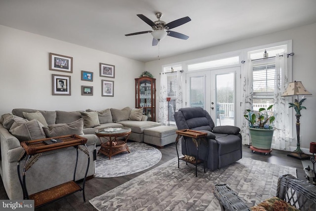 living room with a ceiling fan, wood finished floors, and french doors