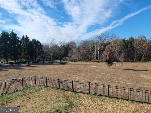 view of yard with a rural view and fence