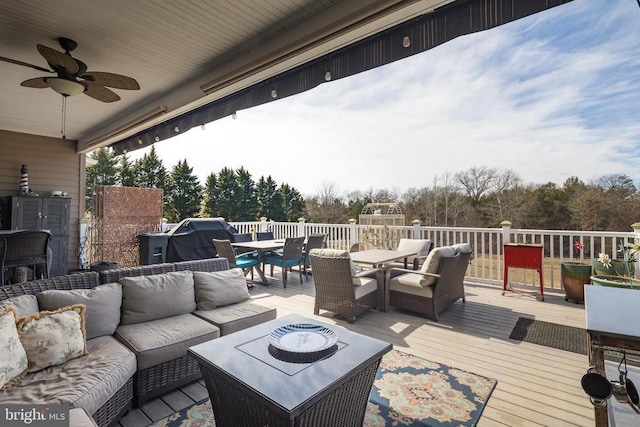 wooden terrace with outdoor lounge area, outdoor dining area, and a ceiling fan