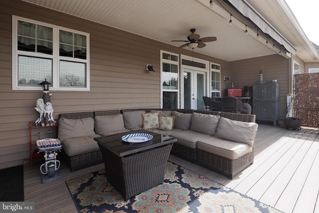 wooden terrace featuring french doors, an outdoor living space, and a ceiling fan