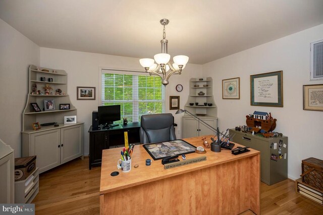 office space featuring a chandelier and light wood finished floors