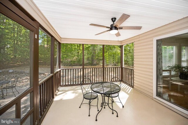 sunroom featuring a ceiling fan