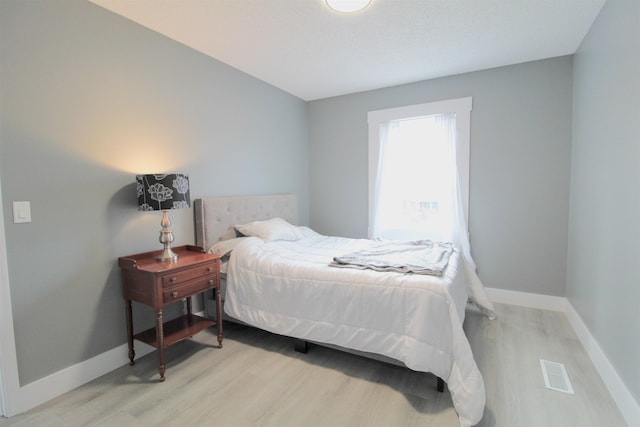 bedroom with light hardwood / wood-style floors