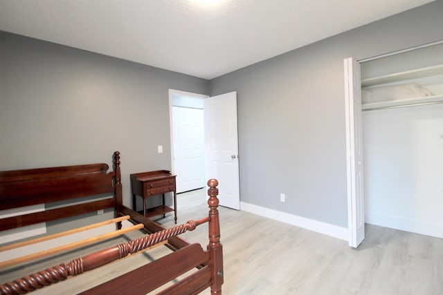 bedroom featuring a closet and light wood-type flooring