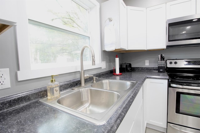 kitchen with white cabinetry, appliances with stainless steel finishes, and sink