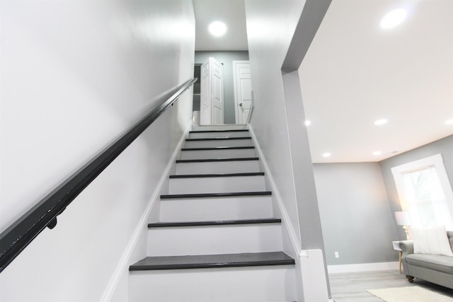 staircase with wood-type flooring