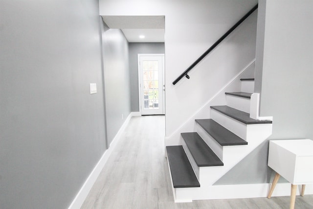 stairs with hardwood / wood-style floors