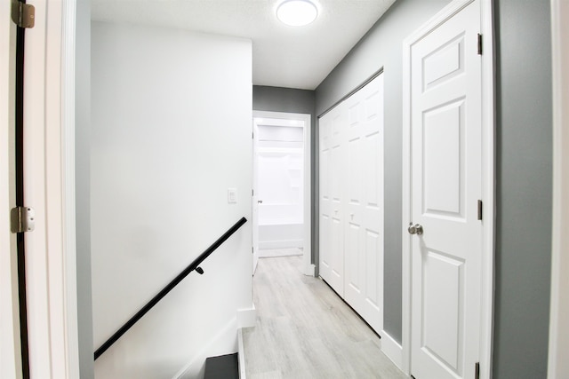 corridor with light hardwood / wood-style floors