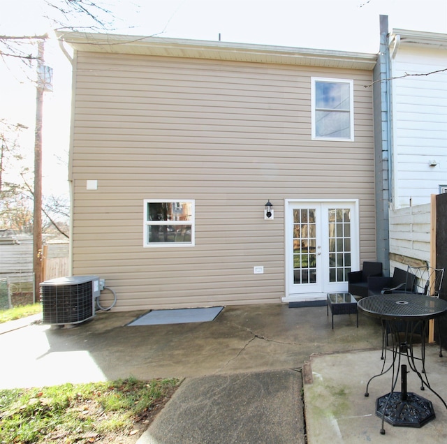 back of property with cooling unit, a patio area, and french doors