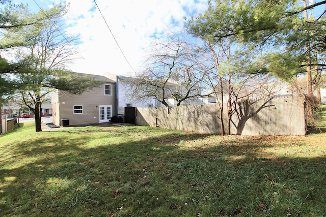 view of yard featuring cooling unit and french doors